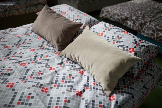 Many multicolored beds with pillows and linens in the interior of the gym