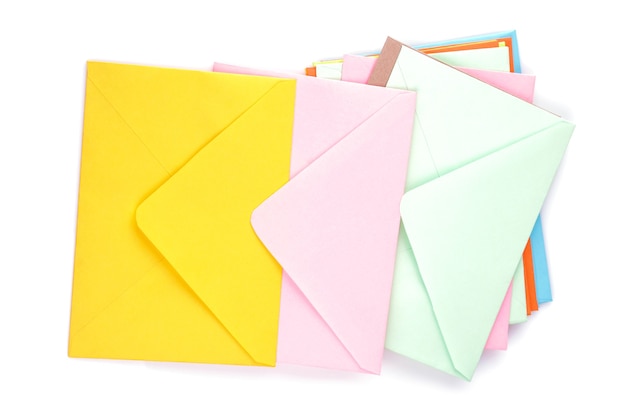 Many multicolored postal envelopes on a white isolated background. mail concept. top view