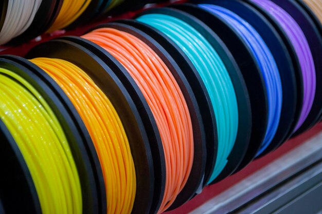 Many multicolored spools of thread of filament for printing d printer material coils for printing d