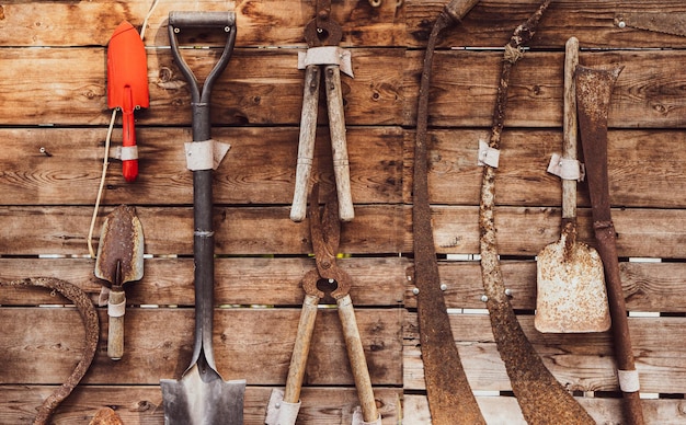 Many old garden equipment on wooden background