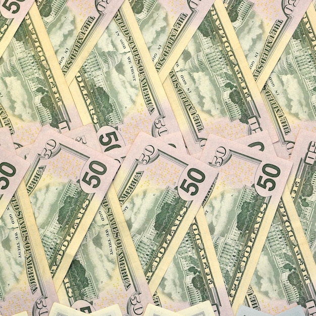 Many one hundred and fifty dollar bills on flat background surface close up Flat lay top view