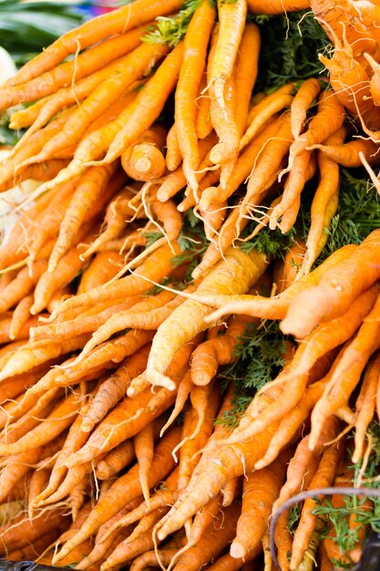 Many orange carrots at the local farmer's  market.