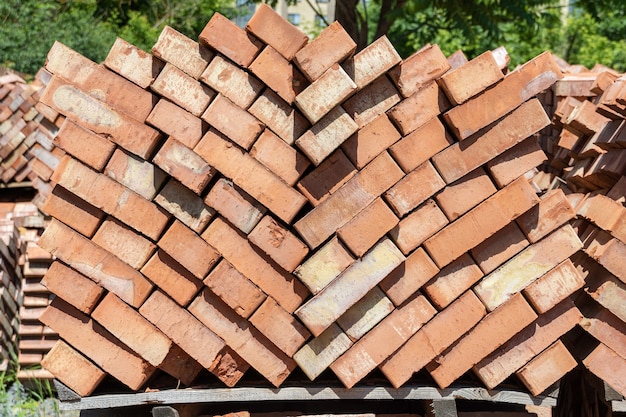 Many pallets of red ceramic bricks at a construction site