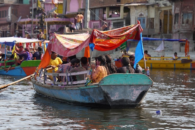 Many people riding on a boat in vrindavan image yamuna river ghat in vrindavan