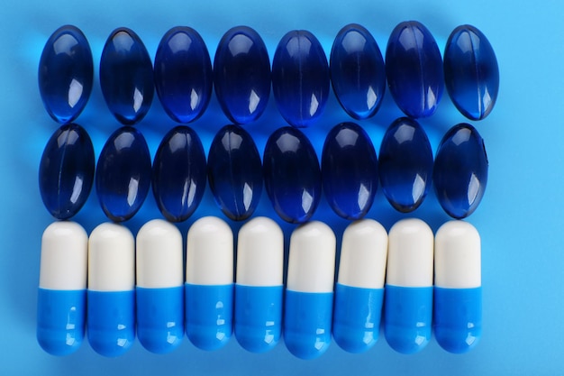 Photo many pills on blue background