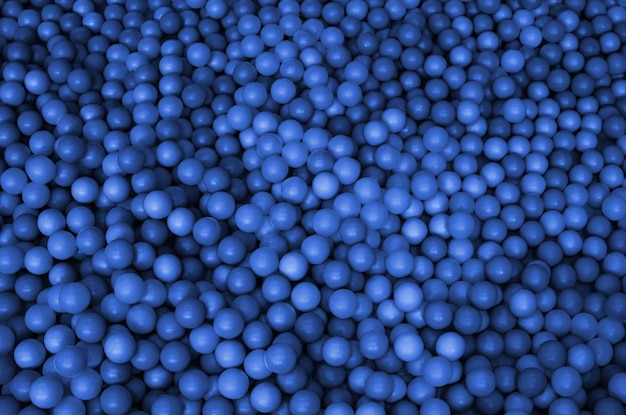 Many plastic balls in a kids ballpit at a playground Close up pattern phantom classic blue color