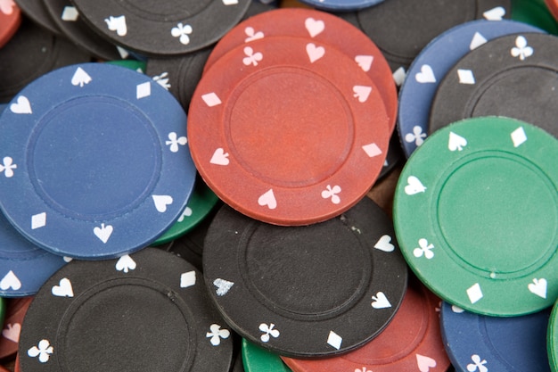 Many poker chips of four different colors