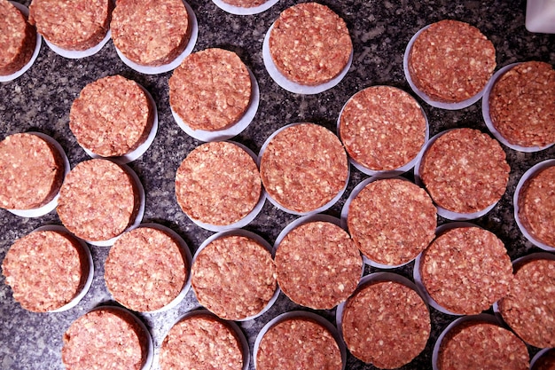 Many raw hamburgers outside the restaurant Starting the preparation of hamburgers Top view