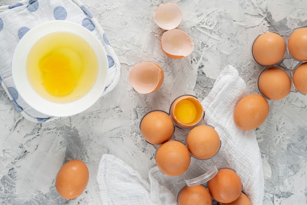 Many raw uncooked chicken eggs in a plastic tray on the grunge table, special egg diets