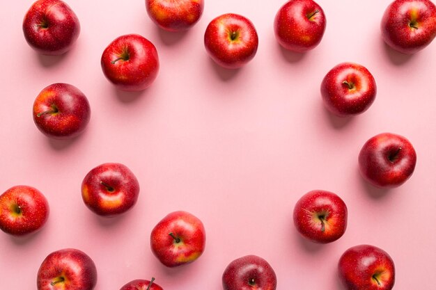 Many red apples on colored background, top view. Autumn pattern with fresh apple above view with copy space for design or text