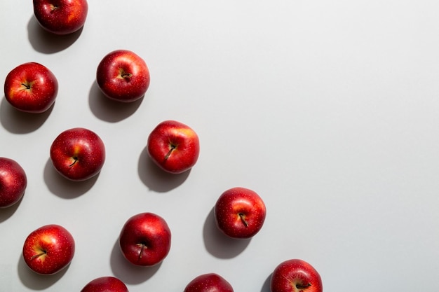 Many red apples on colored background top view Autumn pattern with fresh apple above view with copy space for design or text