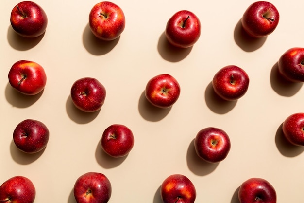 Many red apples on colored background top view Autumn pattern with fresh apple above view