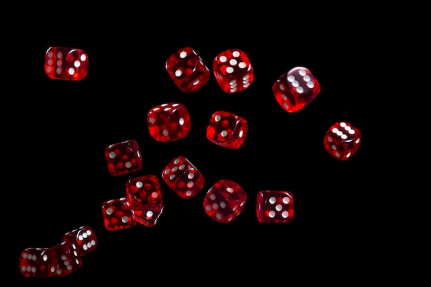 Many red dice flying on black background. Gambling concept.