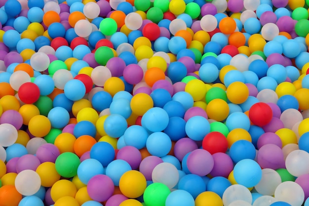 Many small colorful plastic balls in the pool