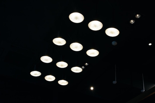 Many small lamps on ceiling in dark