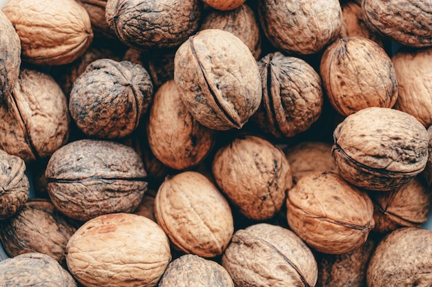 Many tasty walnuts as background