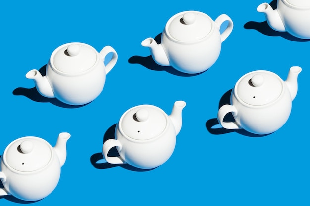 Many teapots on a blue background Tea party concept