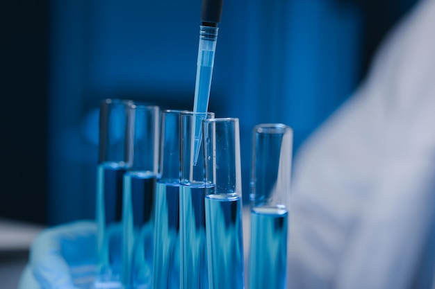 Many test tubes were analyzed by experts A researcher is carefully studying the liquid contained in a test tube because it is an important area of research