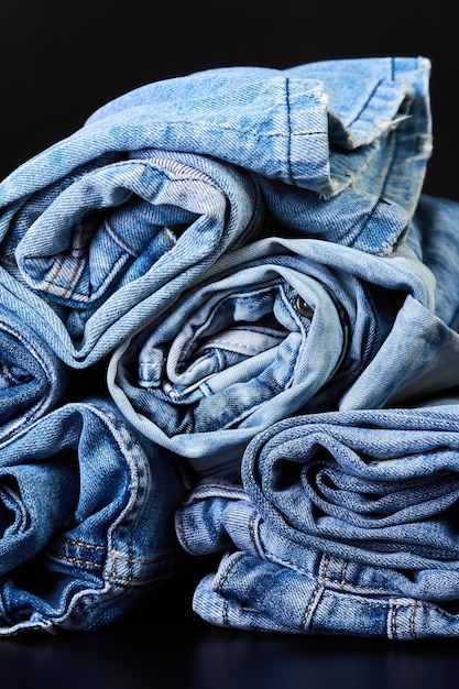 Many twisted jeans on a dark background