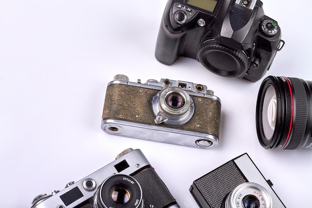 Many various different retro photo cameras on white background