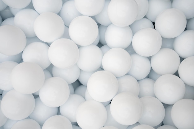 Many white plastic balls for dry pool