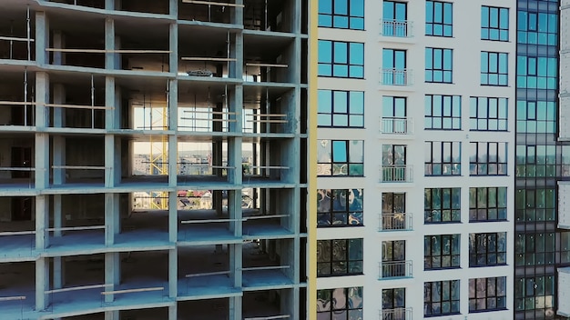 Many windows on new apartment building facade under construction. Real estate development.