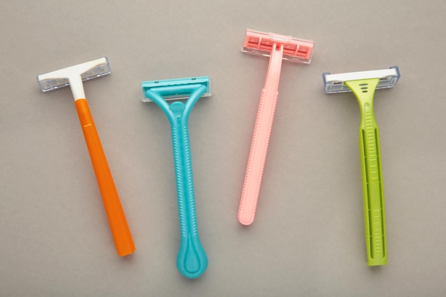 Many women razors on the grey background