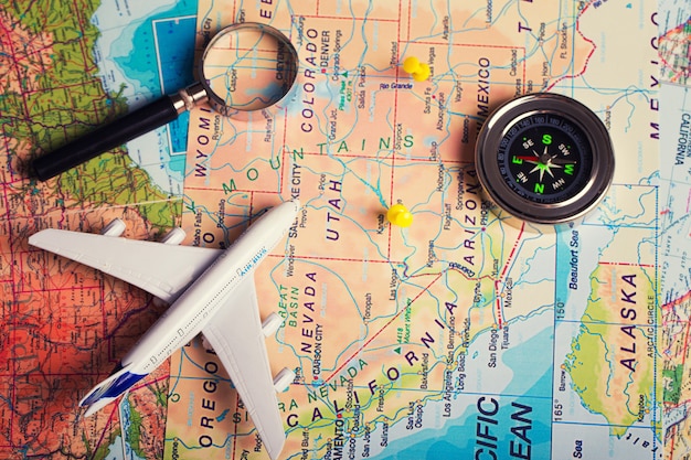 The map, airplane and stuff on a wooden table