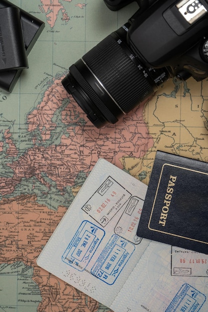 Map of Europe together with a camera and passport with visa stamps Concept of vacation travel travelers Copy space