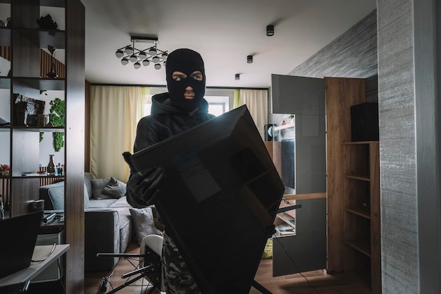 Marauder takes TV out of an empty apartment Apartment theft concept The burglar