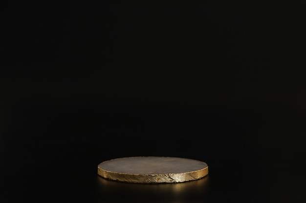 Marble podium with gold on the black background. Podium for product, cosmetic presentation. Creative mock up. Pedestal or platform for beauty products. Minimalist design