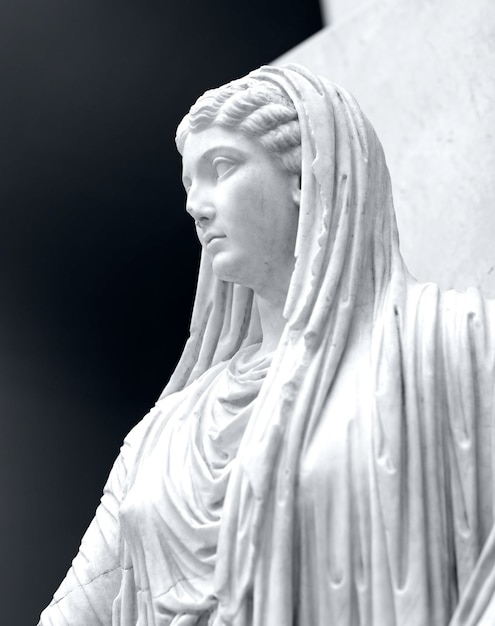 Marble statue of a beautiful young woman with a grey background