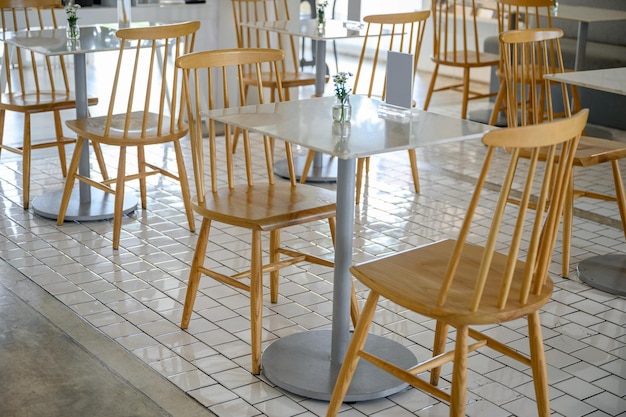 Marble table with wooden chairs and flower decoration