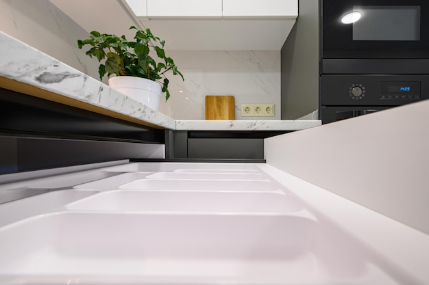 Marble worktop of modern white and dark grey kitchen