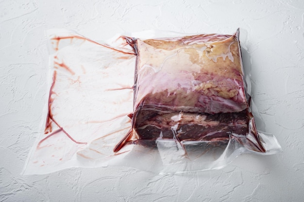 Marbled beef steak cut in vacuum pack on white background