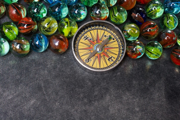 Marbles aand Compass as a concept of traveling and finding your life