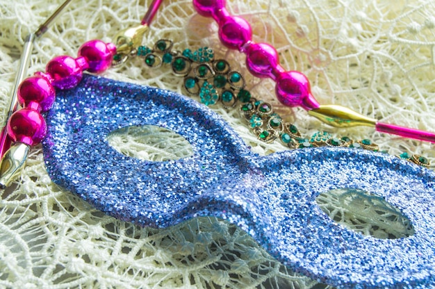 Mardi Gras carnival mask with festive embellishments on the lace