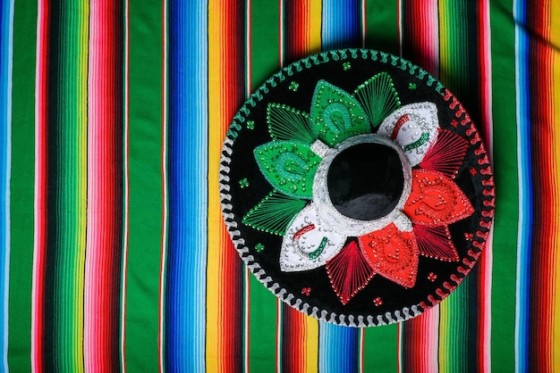 Mariachi hat with the colors of the Mexican flag on a colorful serape