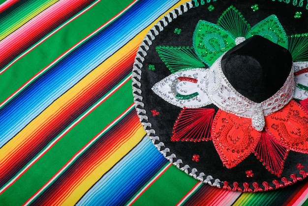 Mariachi hat with the colors of the Mexican flag on a colorful serape