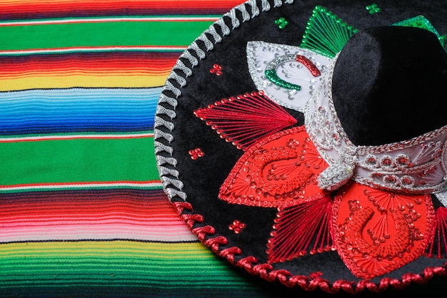 Mariachi hat with the colors of the Mexican flag on a colorful serape