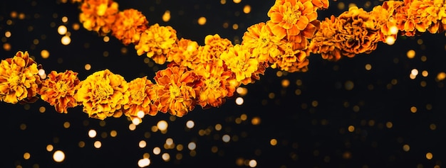 Marigold flowers Garlands on black Dia de los muertos day day of the dead or halloween banner copy space