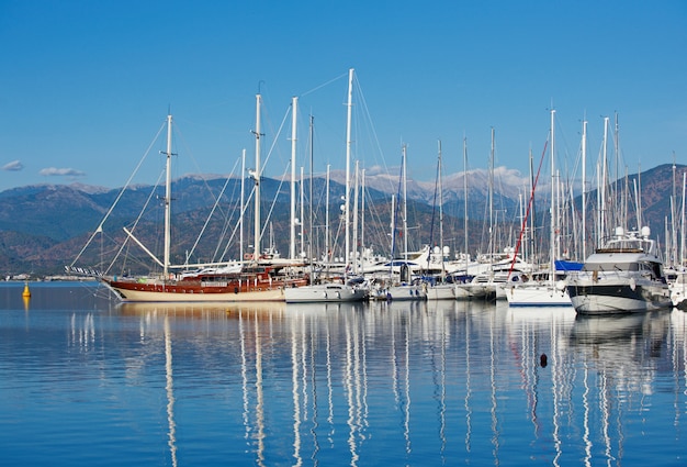 Marina at summer day with moored yachts