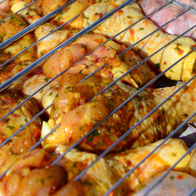 Marinated chicken legs on hot BBQ charcoal field grill