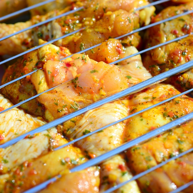 Marinated chicken legs on hot BBQ charcoal field grill