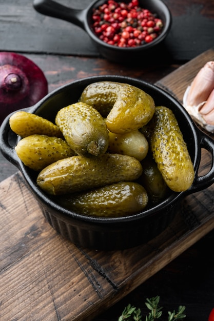 Marinated cucumbers gherkins set, on old dark  wooden table background