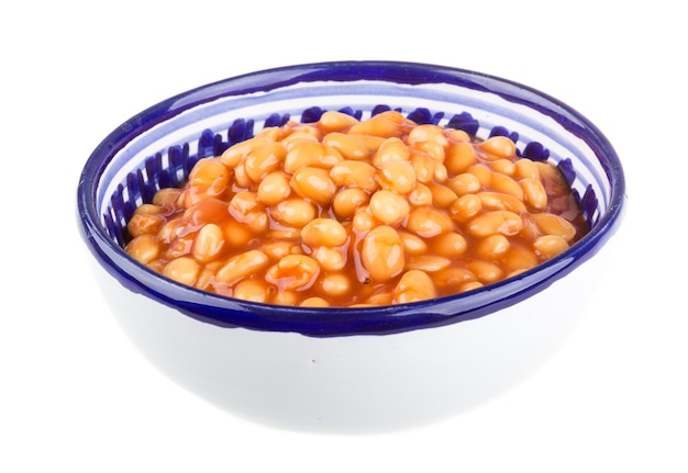 Marinated haricot beans in tomato sauce with shallots on a plate