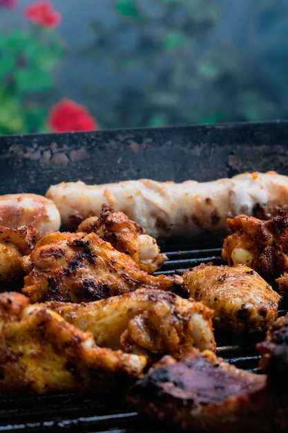 Marinated meat chicken ribs and sausages put on the barbecue