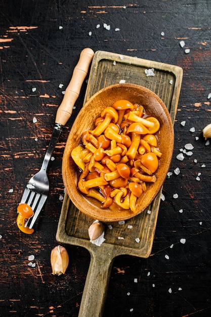 Marinated mushrooms on a cutting board