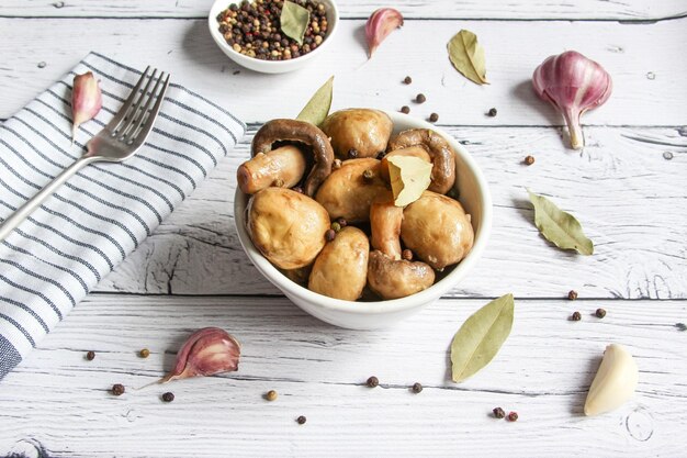 Marinated mushrooms with garlic black pepper and bay leaf Champignon