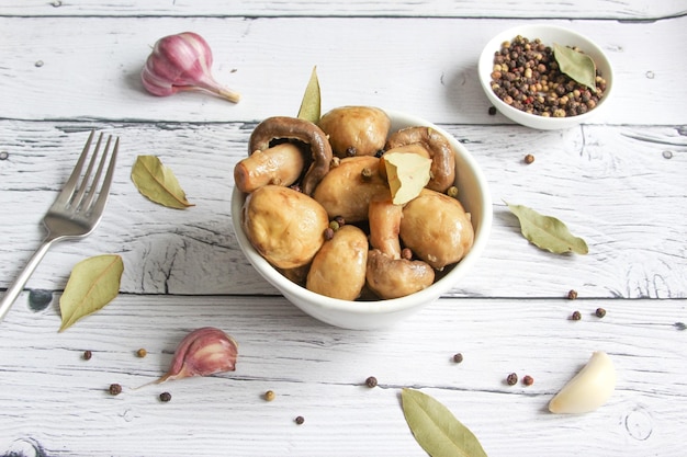 Marinated mushrooms with garlic black pepper and bay leaf Champignons marinated pickled mushrooms